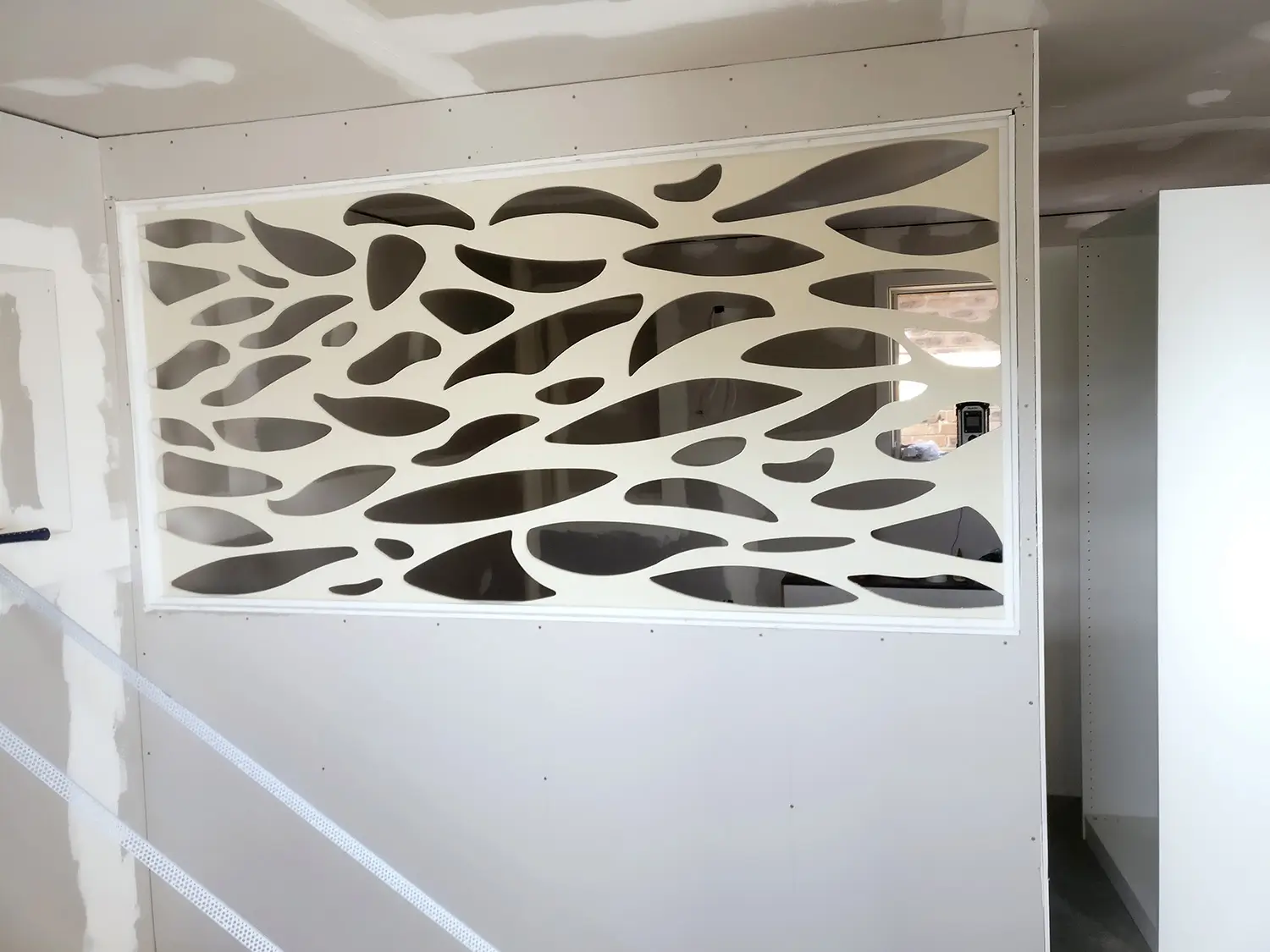 Installing the custom laser-cut timber screen