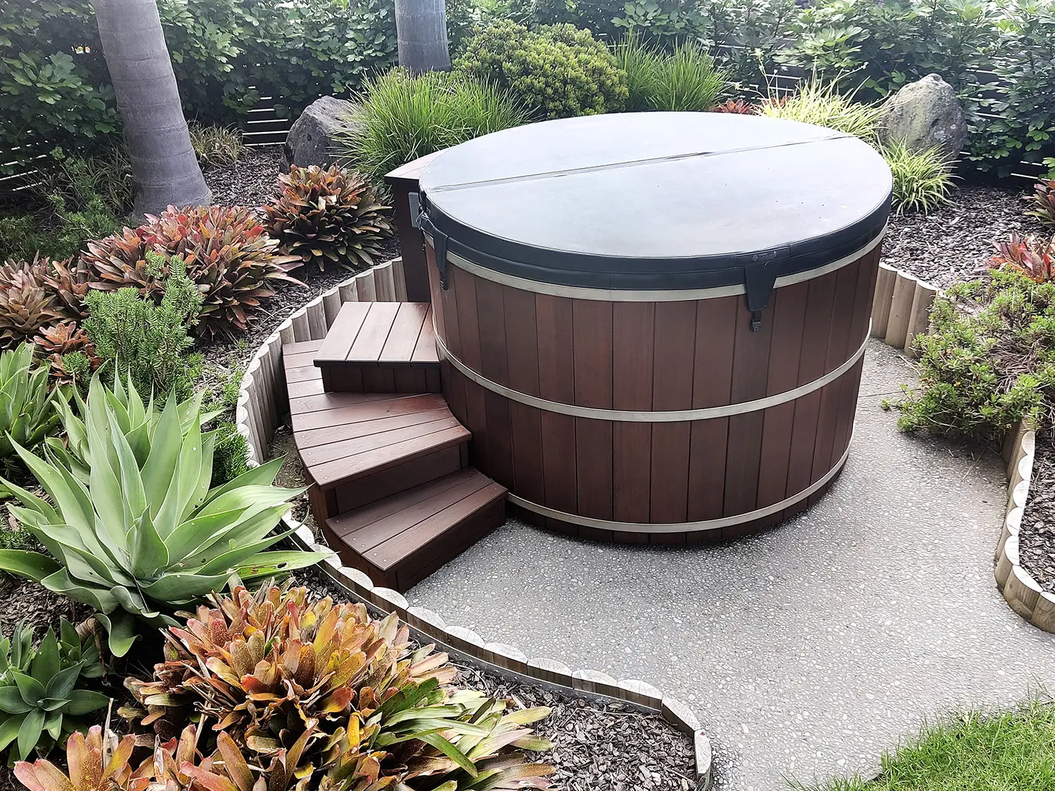 Curved timber steps built to match a hot tub