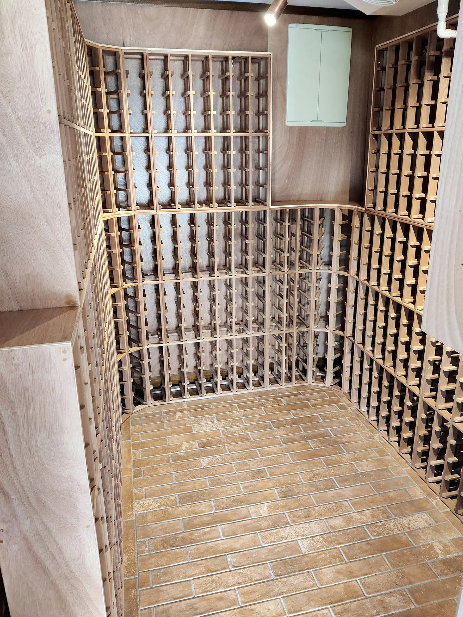 Finished wine cellar with custom curved racking and tiled floor